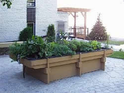 A raised flower garden with a raised bottom